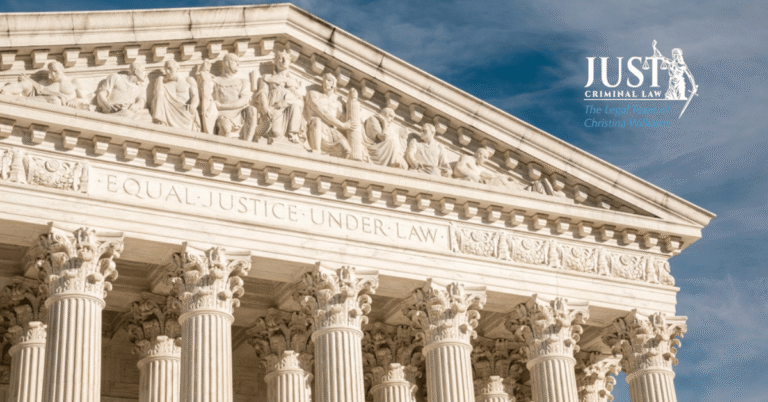 Classical courthouse facade with Corinthian columns and inscription "Equal Justice Under Law," blue sky background.