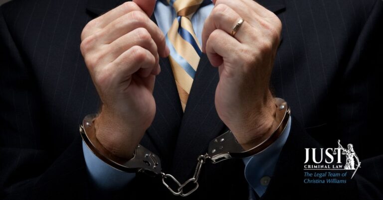 Close-up of a man in a suit with striped tie wearing handcuffs, Just Criminal Law logo visible.