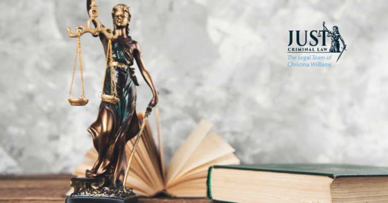 Bronze Lady Justice statue with scales and sword beside open and closed legal books, Just Criminal Law logo.