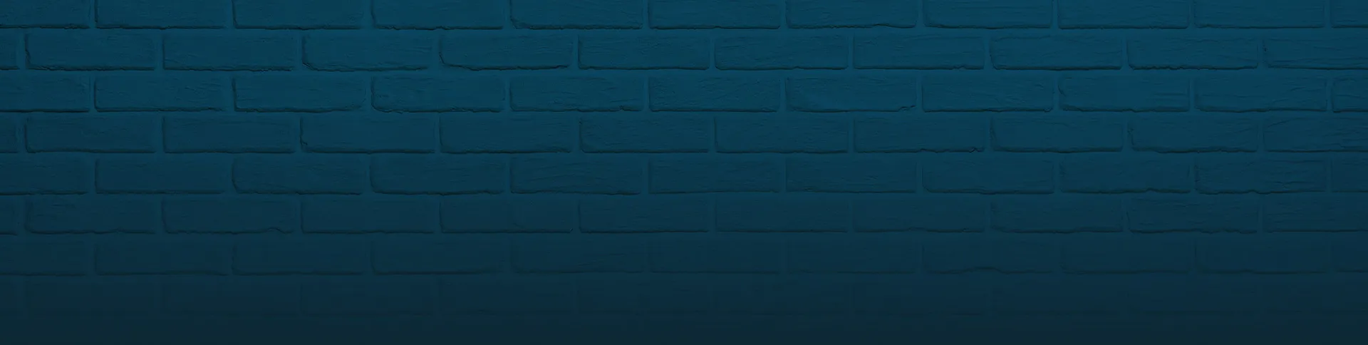 Dark blue brick wall with subtle lighting and texture.