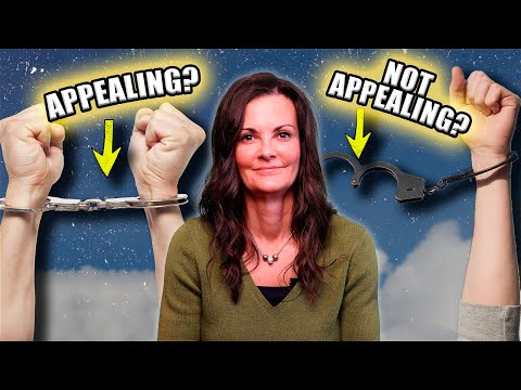 Woman with brown hair and green sweater between two hands, one in handcuffs labeled "APPEALING?" and the other with open handcuffs labeled "NOT APPEALING?