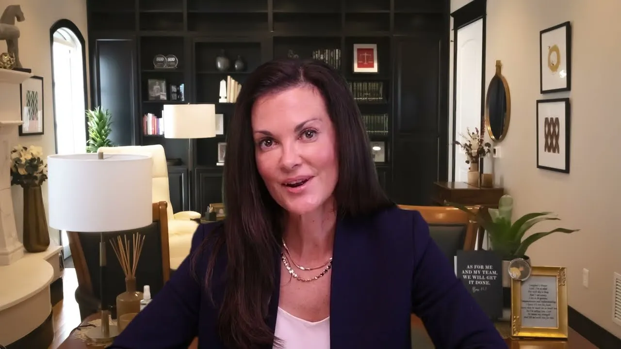 Professional woman with long dark hair speaking in a well-decorated office with bookshelves and framed art.