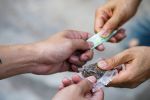 Drug addict buying narcotics and paying,Drug trafficking